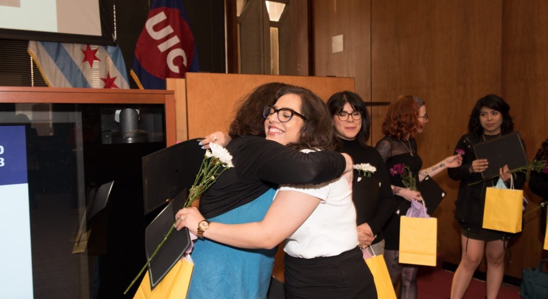 Two people embracing at an awards event for GWS.