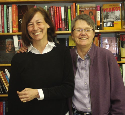 Linda Bubon and Ann Christopherson stand in front of a bookcase