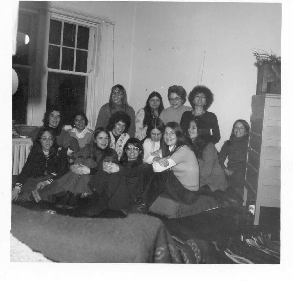 Black and white photo of the Women's Teaching Collective 1974 members seated in a group.