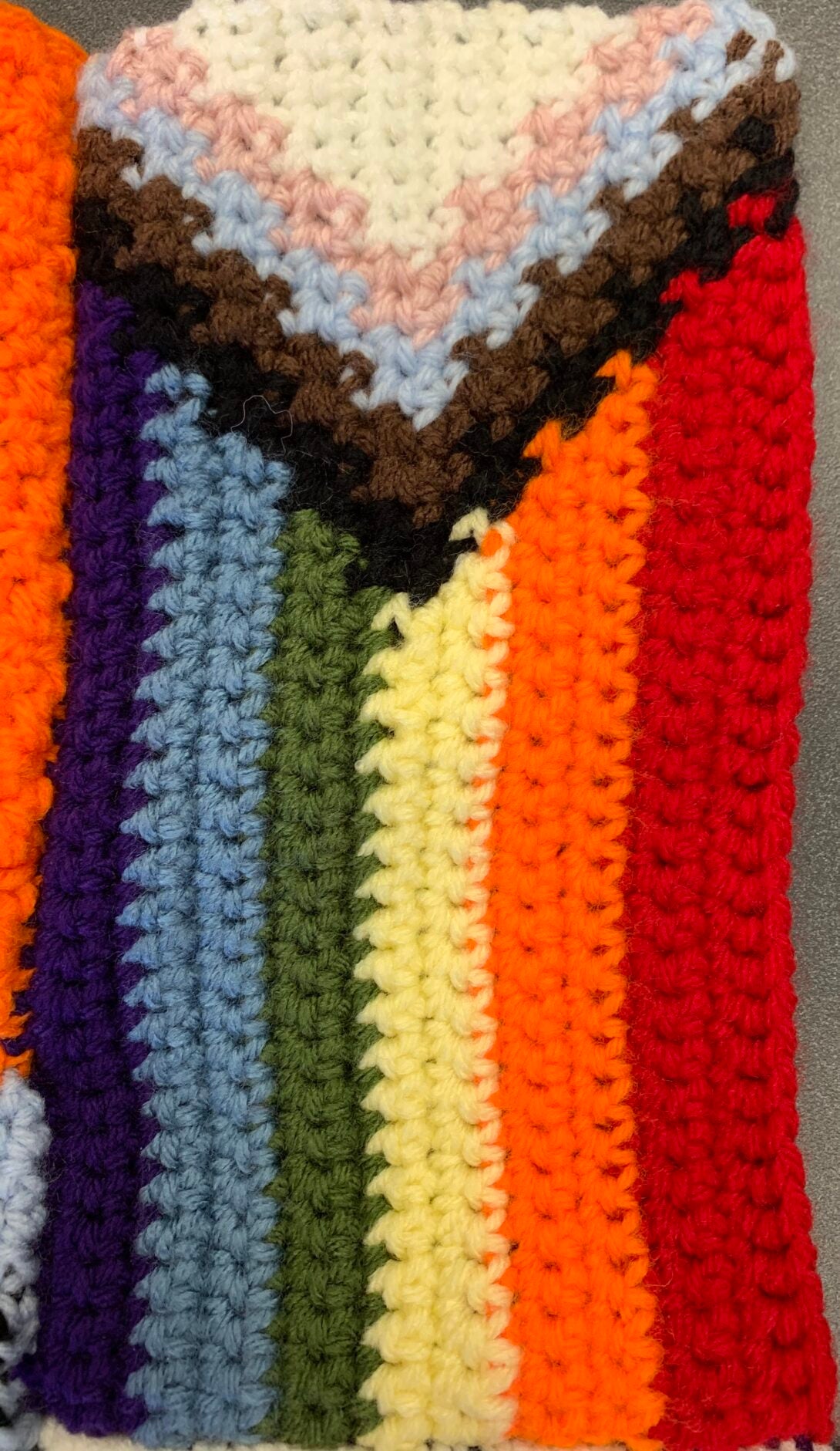 A crocheted progress pride flag